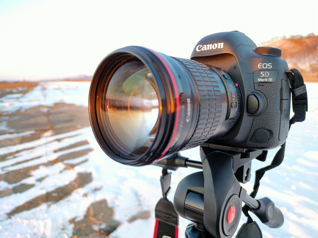 black nikon dslr camera on black tripod