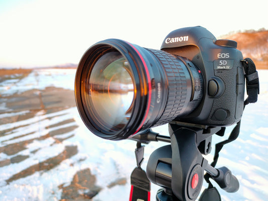 black nikon dslr camera on black tripod